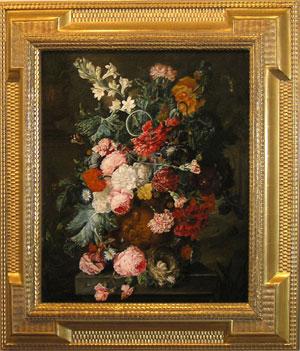 A Still life of summer flowers, roses, carnations, tulips and peonies in a terra cotta figural ur...