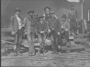Photo of men and boys building a railroad.