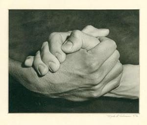 [Black and white photograph of clasped hands].