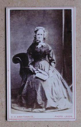 Carte De Visite Photograph: Portrait of a Seated Old Woman Holding a Book.