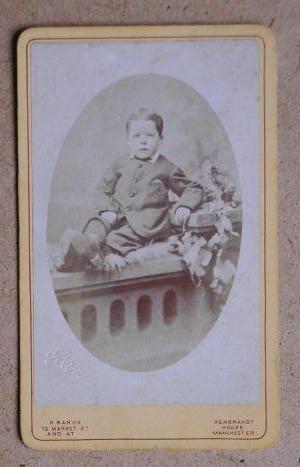 Carte De Visite Photograph: Portrait of a Young Boy Seated on a Stone Balustrade.