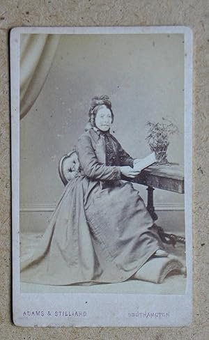 Carte De Visite Photograph. Studio Portrait of a Seated Woman in a Hooped Dress.