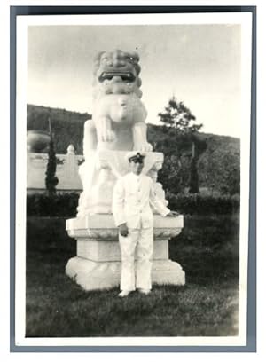 China, Officer near a Chinese temple statue