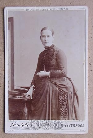 Cabinet Photograph: Studio Portrait of a Finely Dressed Young Woman.
