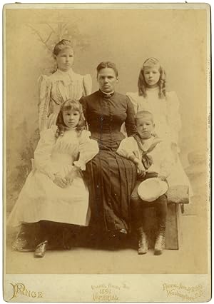 [LARGE CABINET CARD PHOTOGRAPH OF AN AFRICAN- AMERICAN WOMAN AND FOUR WHITE CHILDREN]