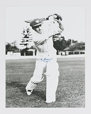 A signed photograph (303 × 240 mm) of Don Bradman executing a straight drive