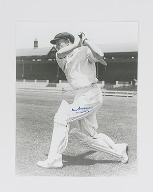A signed photograph of Don Bradman executing a cover drive