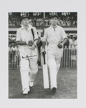 A signed photograph of Don Bradman walking out to bat with Jack Fingleton