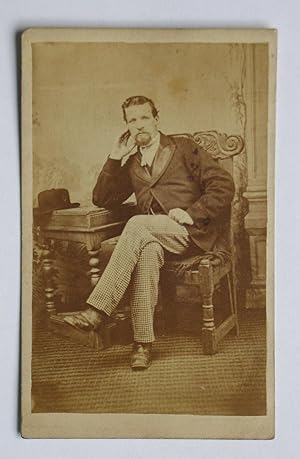 Carte De Visite Photograph. A Studio Portrait of a Relaxed Seated Gentleman.