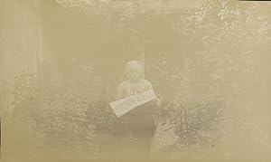 France, Femme lisant le journal "L'Éclair" dans un jardin, 1909, Vintage citrate print