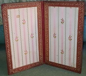 Large leather folder with gilt decoration and silk lining.