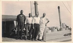 A 1908 VERNACULAR GELATIN SILVER PHOTOGRAPH OF FOUR AFRICAN-AMERICAN LABORERS ABOARD THE SS POWHA...