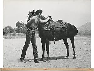 Three Violent People (Original photograph of actor Tom Tryon mounting a horse on the set of the 1...
