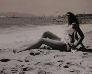 Miss Festival sitting on the beach.Photograph from the 1970 Cannes Film Festival.