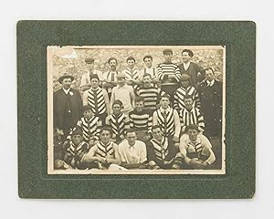 A vintage photograph of an early unidentified Australian Rules Football team, featuring an Indige...