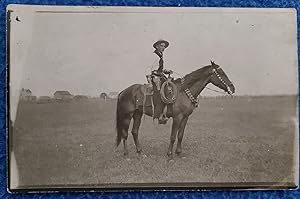 ARMED COWBOY ON HORSE PHOTO
