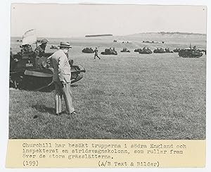 An original Second World War press photograph of Prime Minister Winston S. Churchill observing ar...