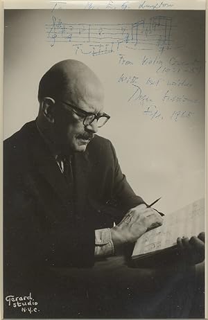 Photograph of the composer, manuscript in hand, with autograph musical quotation from his Violin ...