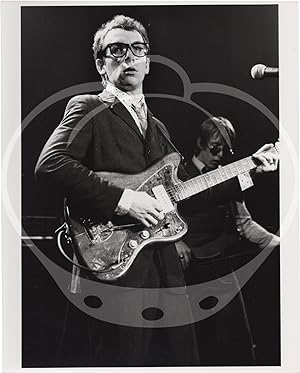 Collection of eight original photographs of Elvis Costello and the Attractions in concert, circa ...