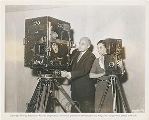 Original photograph of Cecil B. DeMille with two film cameras, circa 1932