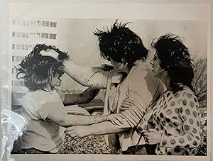 Press photo of a fight between teen punk girl gangs -- England, 1964