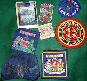 Brough Nicholson & Hall: A Wove silk Ben Nevis 4406ft clothing badge on dark blue baize. and othe...