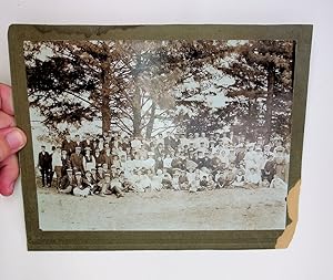 [photograph] Large gathering of people with violin and accordion in the woods