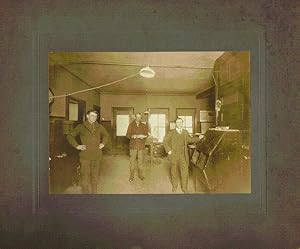 Photograph of three men in a Pittsburgh post office, ca. 1910