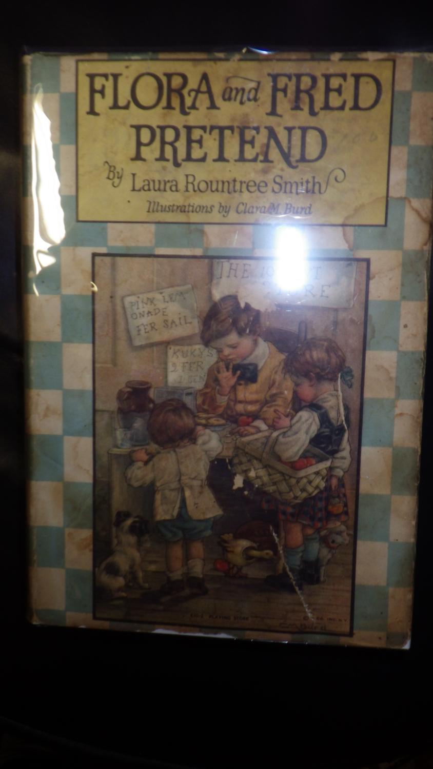 Flora and Fred Pretend in Color Dustjacket of Boy Seated at Table wearing Purple Bowtie Yellow Sweater & White shirt with Little Girl Standing with B
