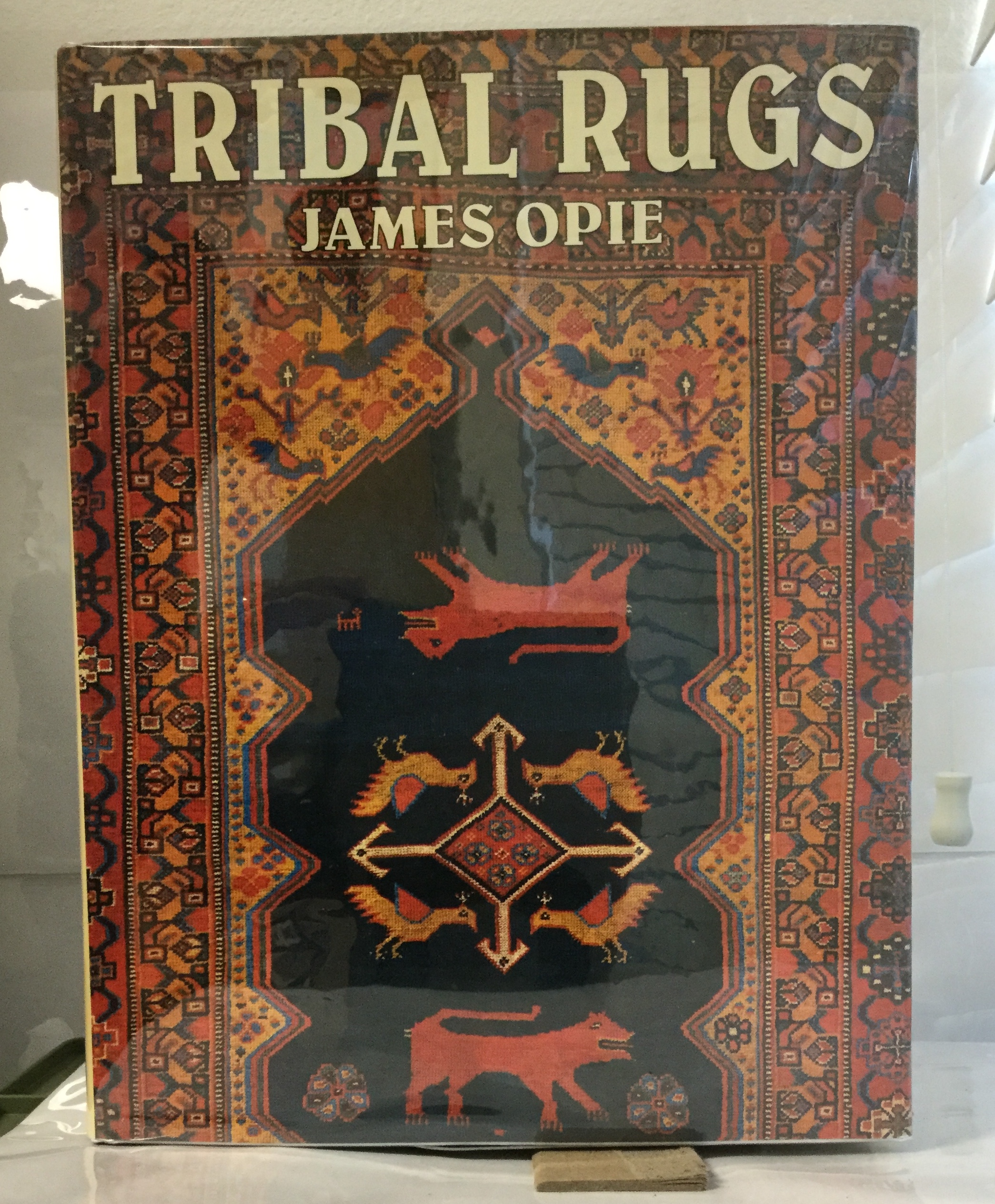 Tribal Rugs Nomadic and Village Weavings from the Near East and Central Asia Opie, James [Near Fine] [Hardcover] NF, in NF DJ. Signed by author on title page. Minimal signs of wear to exterior, binding solid and straight, interior clean and unmarked. Jacket bright and fully intact. An excellent example in an excellent jacket.