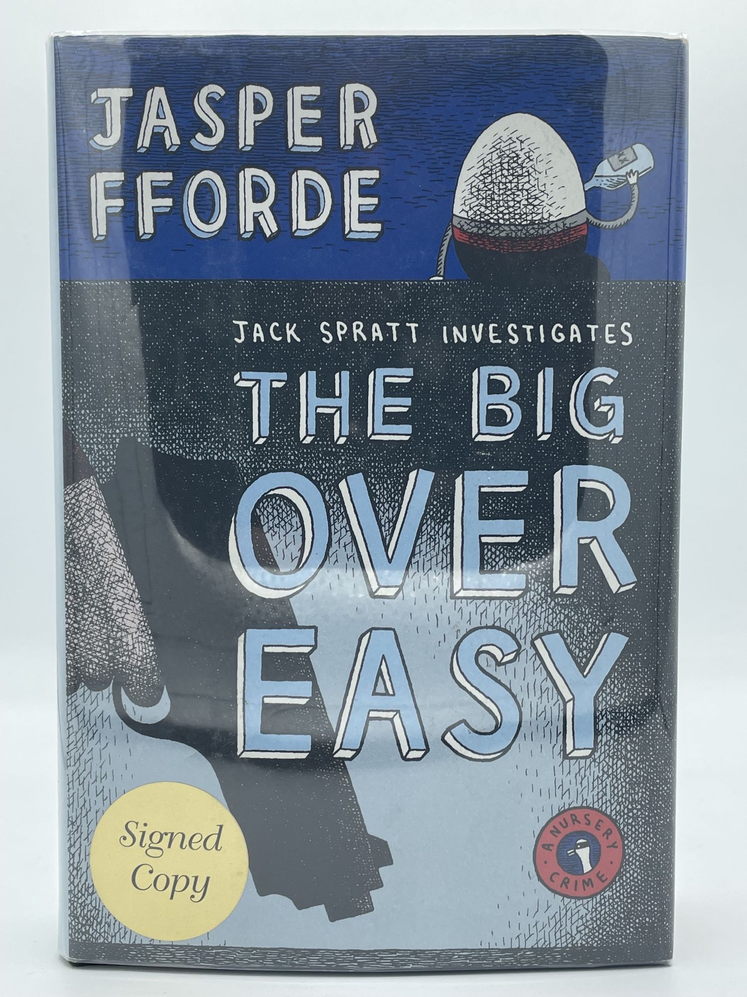 The Big Over Easy; A Nursery Crime FFORDE, Jasper [SIGNED] [Fine] [Hardcover] 8vo. Boards. Dust jacket. 383 pp. Signed on tipped in page.  Signed copy  sticker on front cover. A fine copy. This is a signed first printing of the first volume of Fforde's Jack Spratt series.