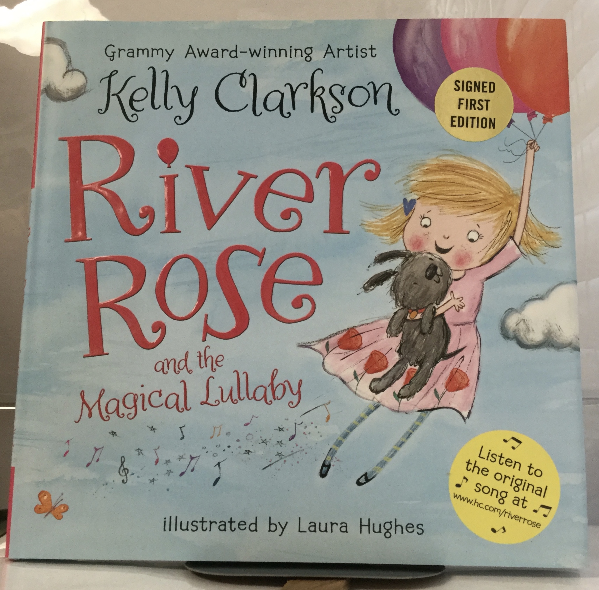 River Rose and the Magical Lullaby Clarkson, Kelly [Very Good] [Hardcover] VG+, in VG+ DJ. Signed by author (Grammy-winning artist Kelly Clarkson) in yellow ink on ffep,  signed first edition  sticker on DJ. First Edition, First Printing (complete number line). Only very light signs of wear to exterior, two spots (one on top edge and one on bottom edge) where bumping has occured, binding solid and straight, interior clean and unmarked. Jacket has only very light signs of general wear, else fully intact and in great shape. Appears unread, a very nice copy in a very nice jacket.