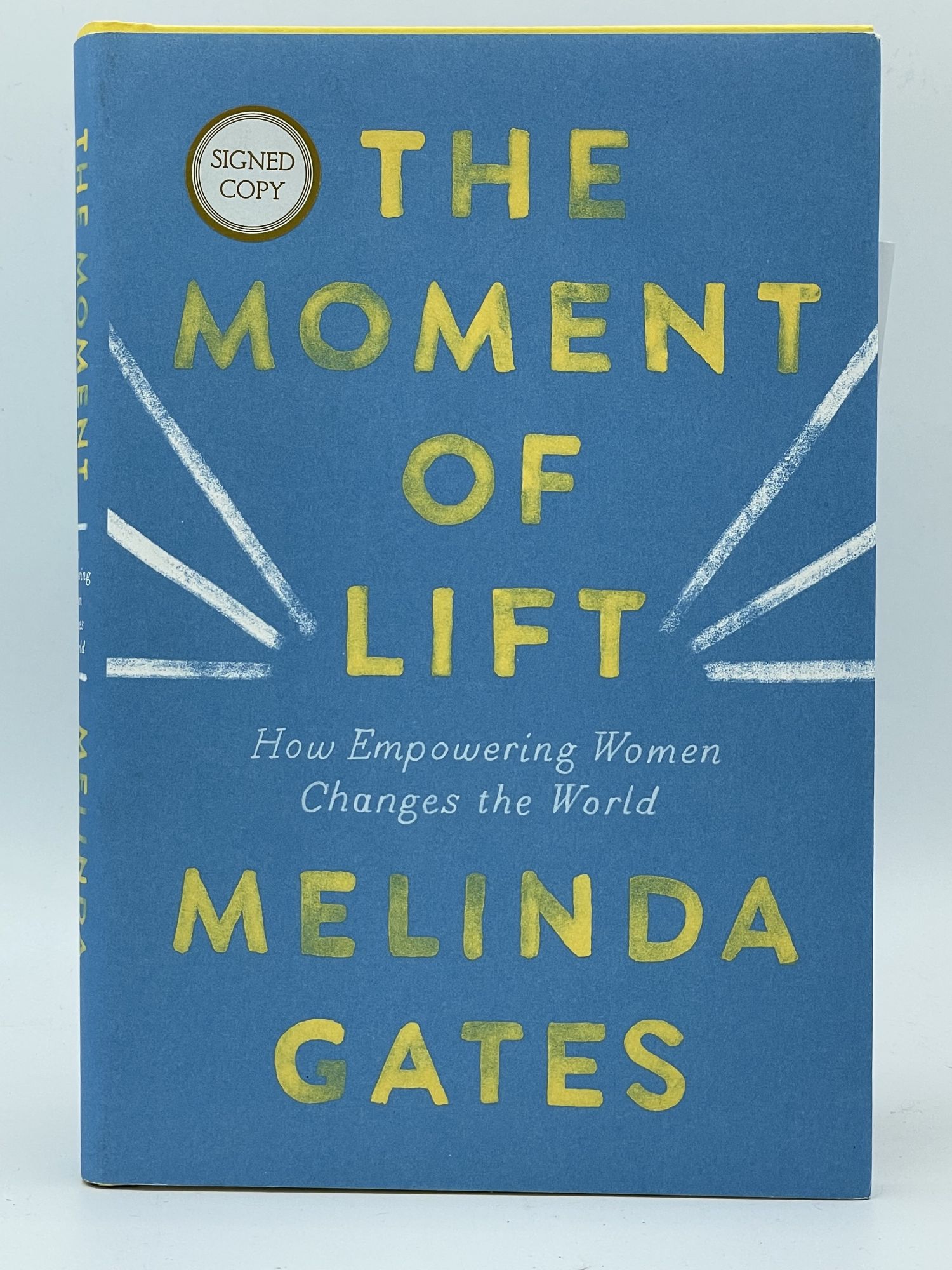 The Moment of Lift; How empowering women changes the world GATES, Melinda [SIGNED] [Very Good] [Hardcover] 8vo. Boards. Dust jacket. 273 pp. Signed on bound-in page.  Signed copy  sticker on front cover. Minor shelf wear. Comes with 2 postcards from the book's promotional tour. This is a signed copy of Melinda Gates' book about capitalist feminism.