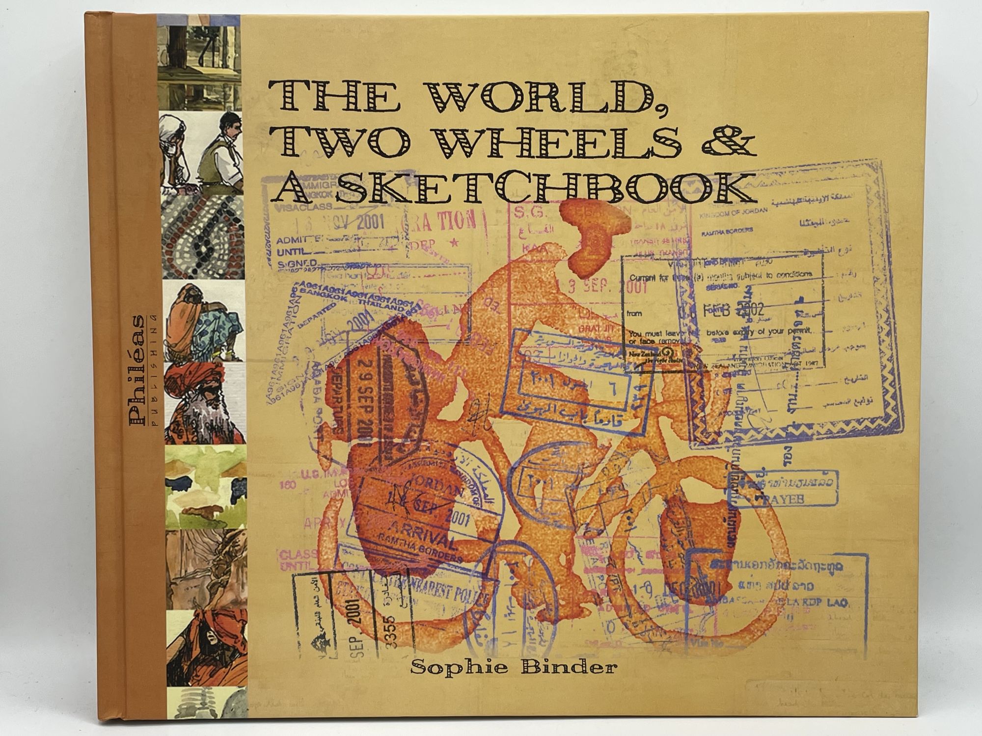 The World, Two Wheels & a Sketchbook BINDER, Sophie [SIGNED] [Very Good] [Hardcover] Oblong 4to. Boards. Full color illustrations. 283 pp. Signed on title page. Sticker residue on rear board. This is a signed travel journal by artist Binder chronicling her solo bicycle adventure around the world.