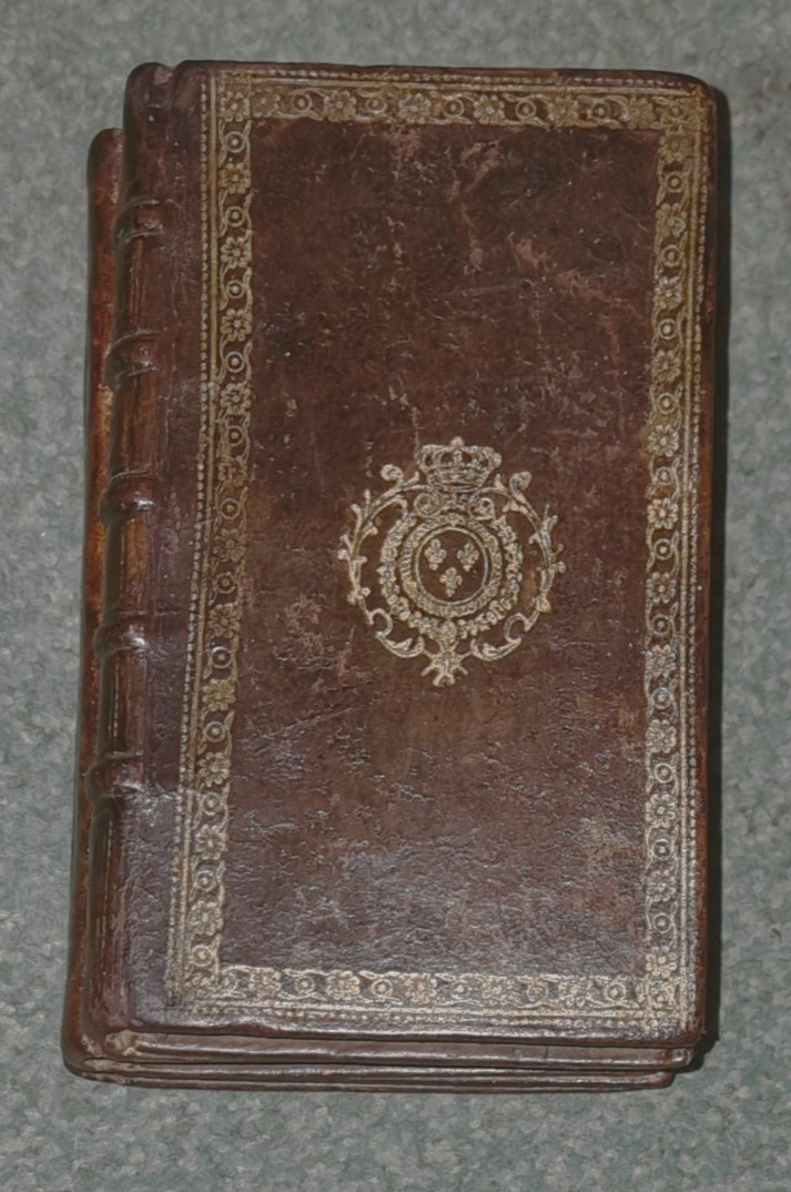 3 Leatherbound books fused together to form a paperweight . by