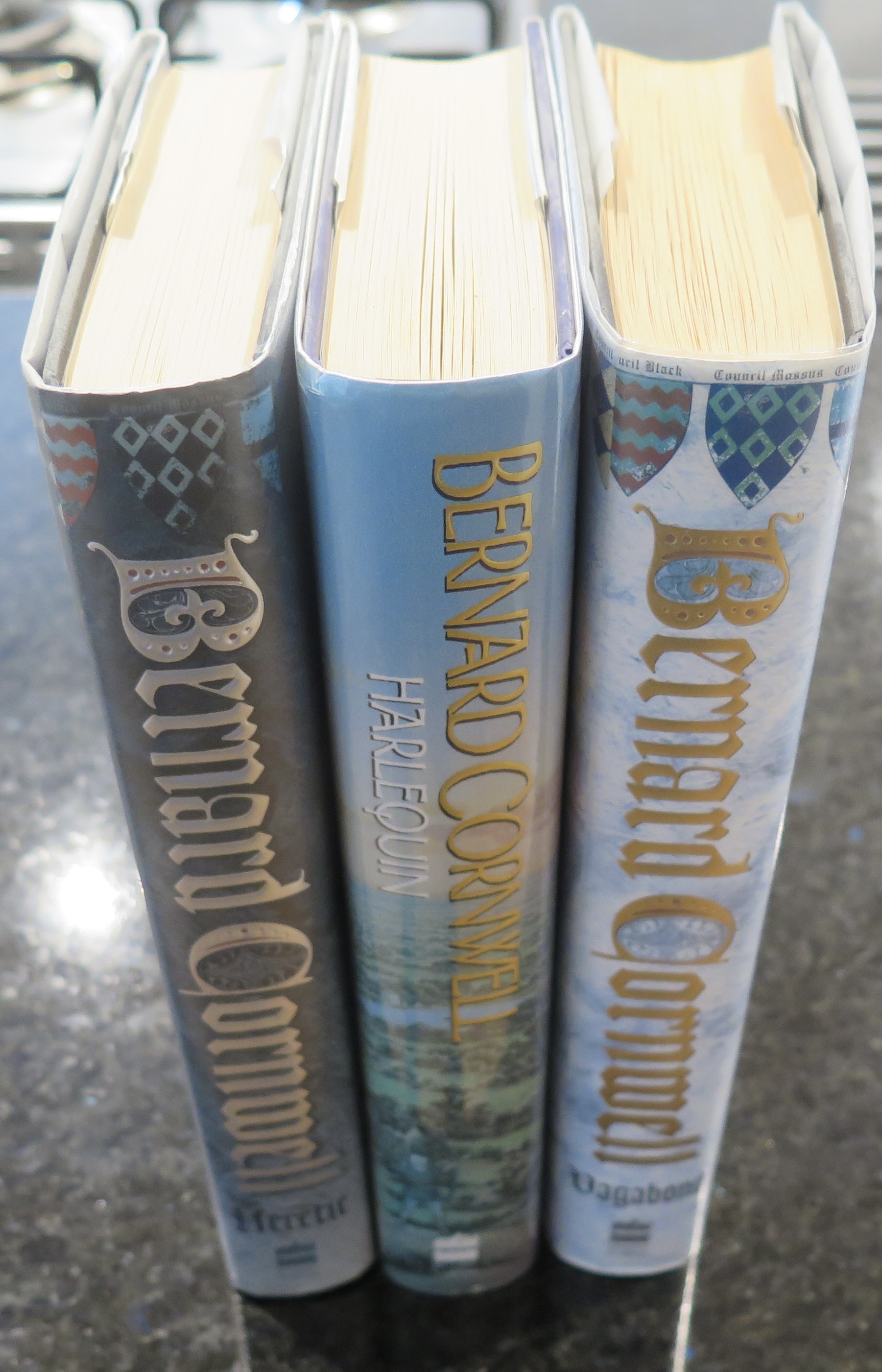 Grail Quest Series;-Harlequin, Vagabond, Heretic. First signed editions Bernard Cornwell [Very Good] [Hardcover]