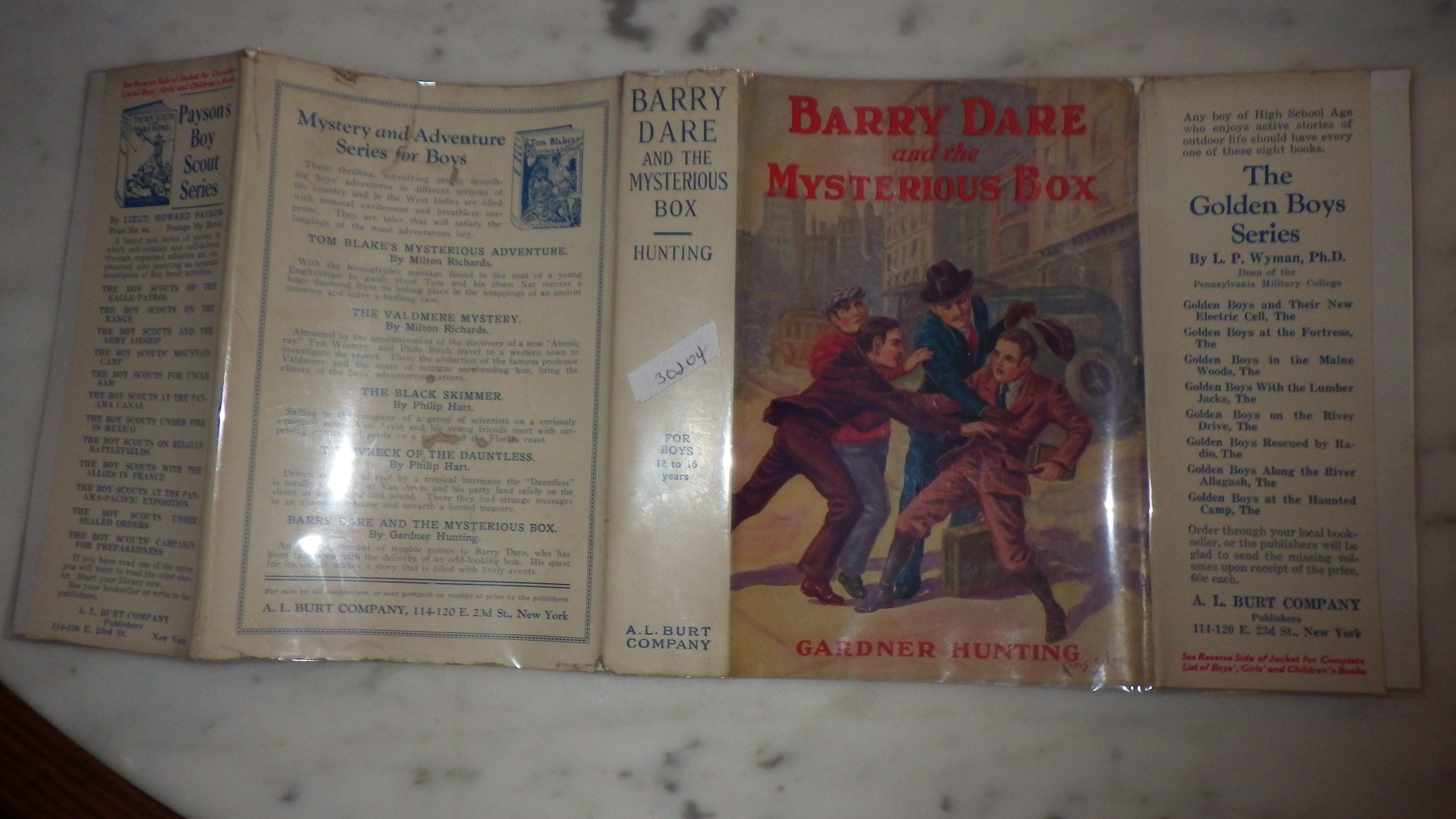 BARRY DARE AND THE MYSTERIOUS BOX BY GARDNER HUNTING IN COLOR DUSTJACKET OF 3 PEOPLE ATTACKING LITTLE BOY IN BROWN KNICKERS & BLACK BOOTS CARRYING A