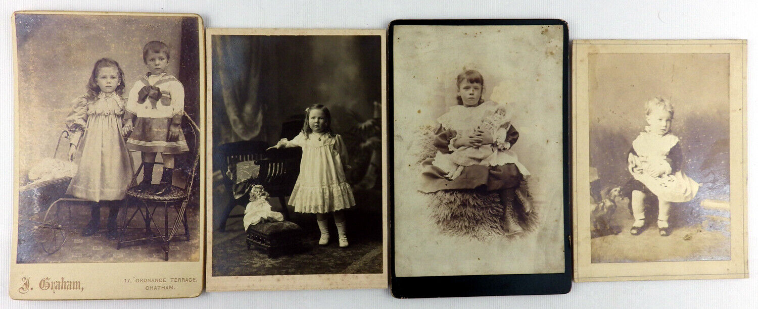 Four antique cabinet card photographs of children with dolls and other toys including a pull-along horse. Including a boy in a sailor suit/dress thin