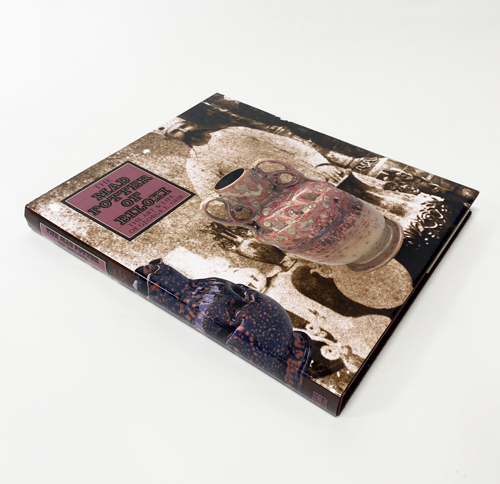 The Mad Potter of Biloxi: The Art & Life of George E. Ohr by Clark, Garth; Ellison, Jr., Robert A.; Hecht, Eugene: Near Fine Cloth (1989) First Edition. | Exquisite Corpse Booksellers The Mad Potter of Biloxi: The Art & Life of George E. Ohr by Clark, Garth; Ellison, Jr., Robert A.; Hecht, Eugene: Near Fine Cloth (1989) First Edition. | Exquisite Corpse Booksellers