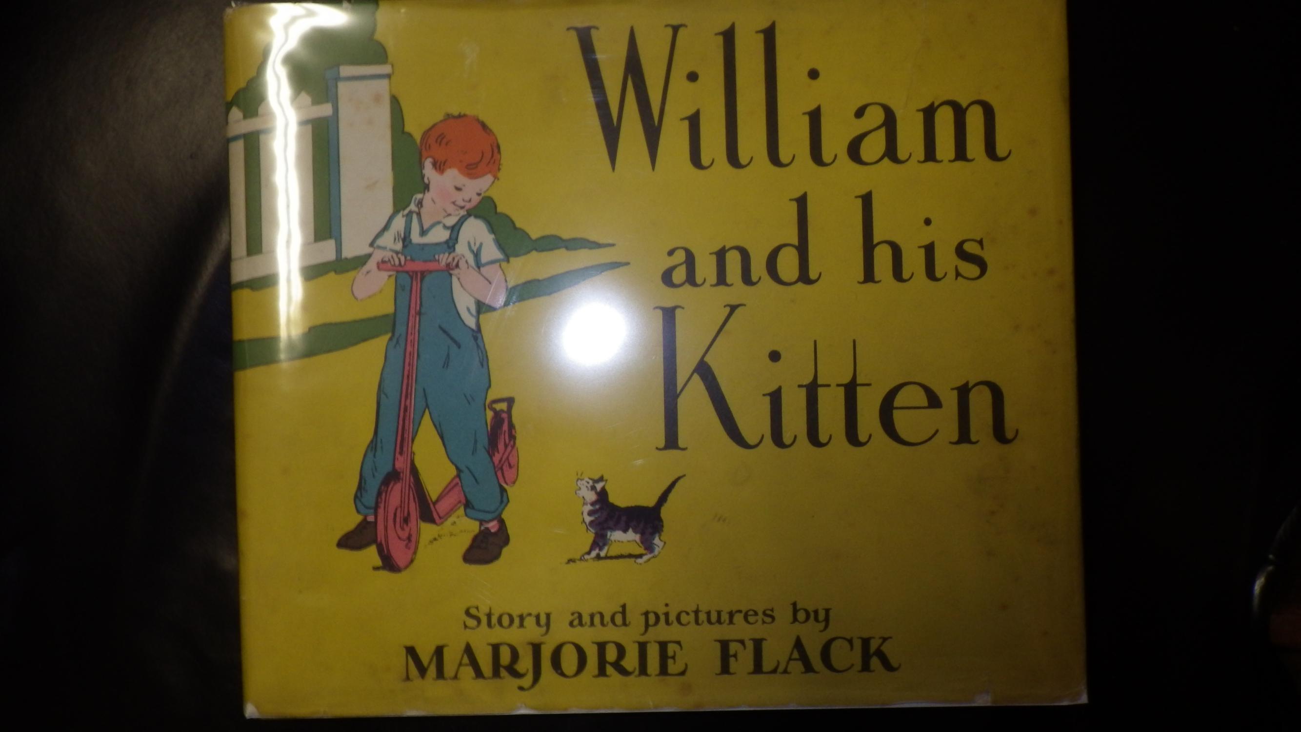 William and his Kitten in Color Dustjacket of Young Boy with Red Hair, Blue Overalls & White Shirt on Red Push Scooter with Black & Grey cat near whi