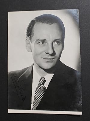 Photograph signed (on a dark portion of the image), head & shoulders, semi profile.