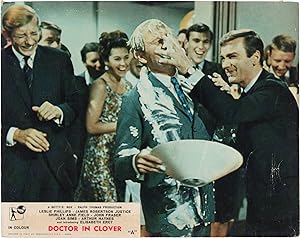 Imagen del vendedor de Doctor in Clover [Carnaby, M. D.] (Original British front-of-house card from the 1966 film) a la venta por Royal Books, Inc., ABAA
