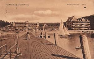 Bild des Verkufers fr Ostseebad Glcksburg. Landungsbrcke u. Hotels. Ansichtskarte in brunlichem Lichtdruck. Abgestempelt Glcksburg 09.09.1910. zum Verkauf von Antiquariat Heinz Tessin