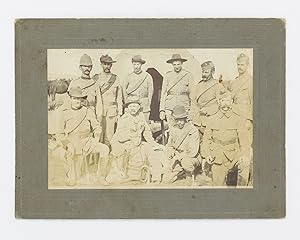 A vintage photograph of a group of eleven Australian soldiers posed in front of a tent, possibly ...
