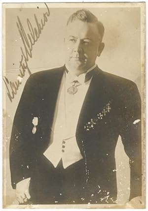 Three-quarter length photograph in formal attire, signed in full