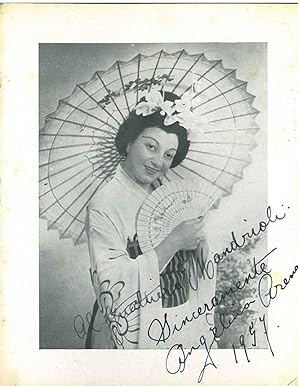 Fotografia originale in forma di cartolina con la cantante in abito da scena e dedica autografa s...