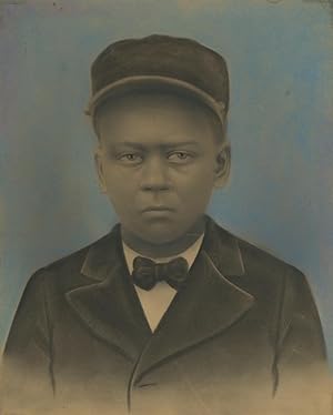 HAUNTING HAND-COLORED PORTRAIT OF A YOUNG AFRICAN-AMERICAN IN A PULLMAN PORTER UNIFORM