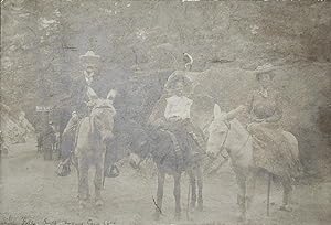 Seven Falls South Cheyenne Cañon, Colo. [sepia photograph of three people on burros]