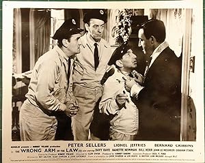 Seller image for The Wrong Arm of the Law' Original Lobby Card; Peter Sellers intimidating delivery men. for sale by Rattlesnake Books