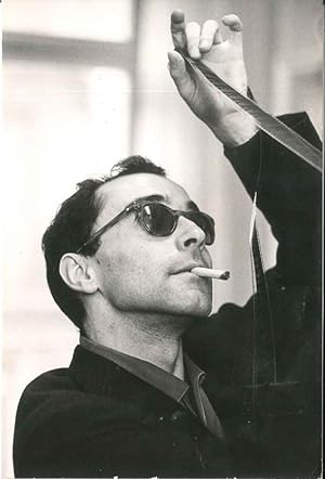 Jean Luc Godard looking the film